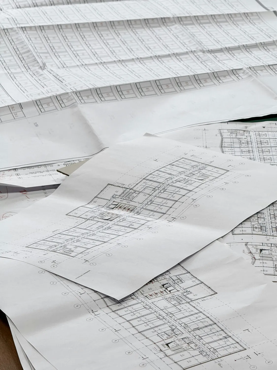 Architectural blueprints spread across a work surface